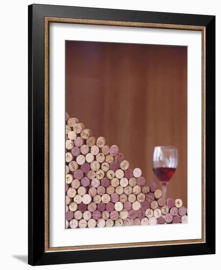 Wine Corks, Piled Up, and a Glass of Red Wine-Henrik Freek-Framed Photographic Print