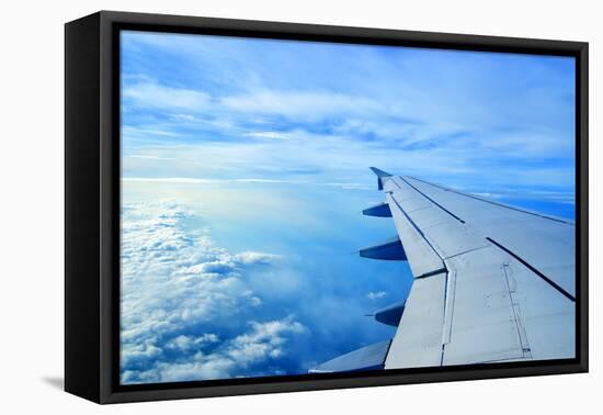 Wing of an Airplane Flying Above the Clouds-ghoststone-Framed Premier Image Canvas