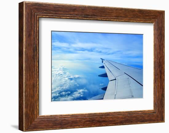 Wing of an Airplane Flying Above the Clouds-ghoststone-Framed Photographic Print