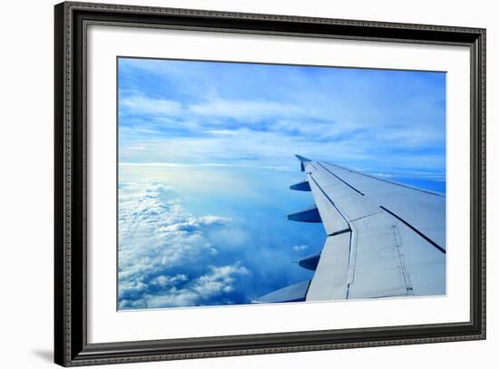 Wing of an Airplane Flying Above the Clouds-ghoststone-Framed Photographic Print