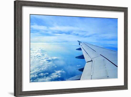 Wing of an Airplane Flying Above the Clouds-ghoststone-Framed Photographic Print