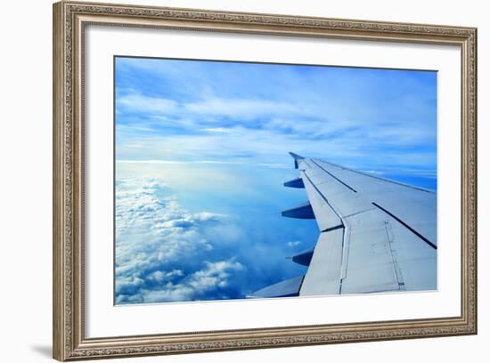 Wing of an Airplane Flying Above the Clouds-ghoststone-Framed Photographic Print