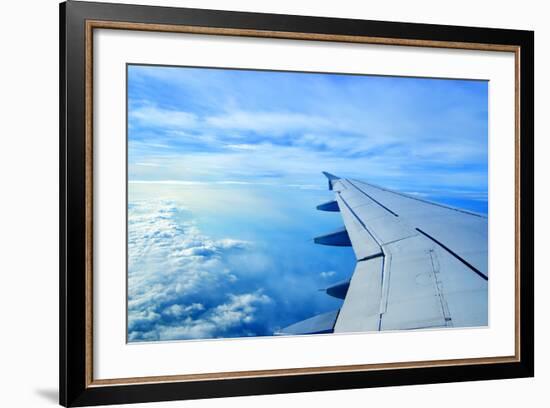 Wing of an Airplane Flying Above the Clouds-ghoststone-Framed Photographic Print