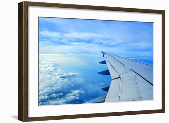 Wing of an Airplane Flying Above the Clouds-ghoststone-Framed Photographic Print