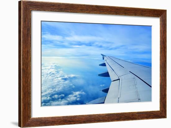 Wing of an Airplane Flying Above the Clouds-ghoststone-Framed Photographic Print