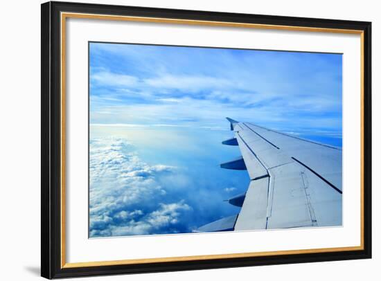 Wing of an Airplane Flying Above the Clouds-ghoststone-Framed Photographic Print