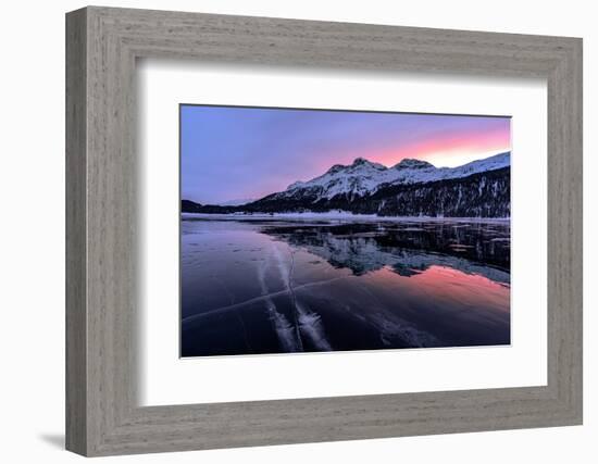 Winter sunrise on snowcapped mountains mirrored in the icy Lake Silvaplana, Maloja-Roberto Moiola-Framed Photographic Print