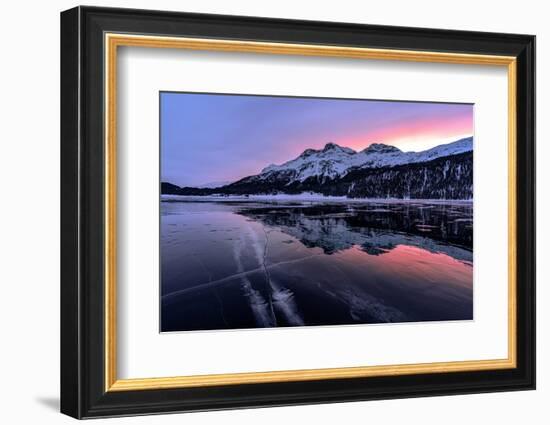 Winter sunrise on snowcapped mountains mirrored in the icy Lake Silvaplana, Maloja-Roberto Moiola-Framed Photographic Print