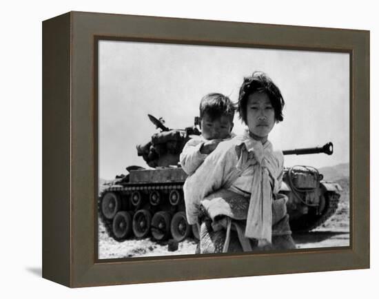 With Her Brother on Her Back, a War Weary Korean Girl Tiredly Trudges by a Stalled M-26 Tank-null-Framed Stretched Canvas