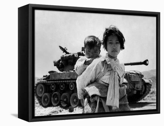 With Her Brother on Her Back, a War Weary Korean Girl Tiredly Trudges by a Stalled M-26 Tank-null-Framed Stretched Canvas