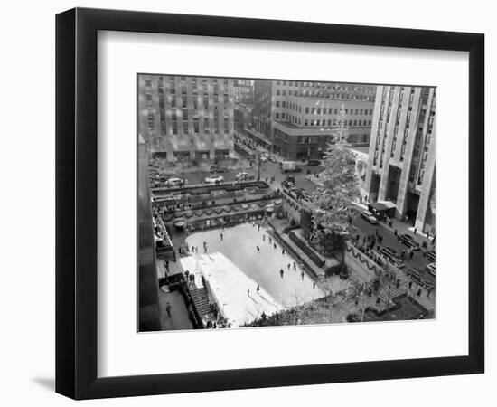 With the Famed Rockefeller Center Christmas Tree Rising Above Them, Skaters Glide on the Ice-null-Framed Photographic Print