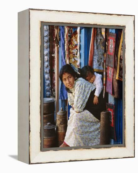 Woman and Baby, Cloth Shopkeeper in Temple Square, Bodhnath, Kathmandu, Nepal-Anthony Waltham-Framed Premier Image Canvas