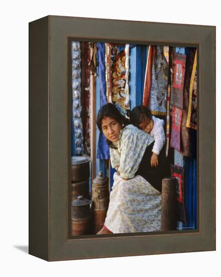 Woman and Baby, Cloth Shopkeeper in Temple Square, Bodhnath, Kathmandu, Nepal-Anthony Waltham-Framed Premier Image Canvas