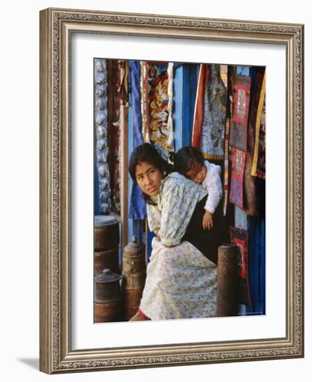 Woman and Baby, Cloth Shopkeeper in Temple Square, Bodhnath, Kathmandu, Nepal-Anthony Waltham-Framed Photographic Print