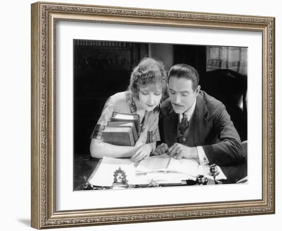 Woman and Man Sitting Together and Looking at a Book-null-Framed Photo