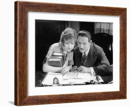 Woman and Man Sitting Together and Looking at a Book-null-Framed Photo