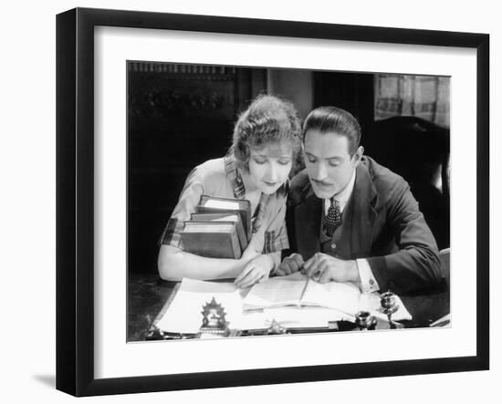 Woman and Man Sitting Together and Looking at a Book-null-Framed Photo