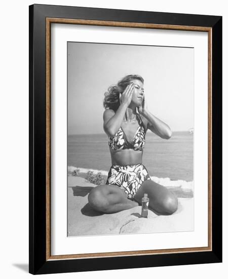 Woman Applying Suntan Lotion at the Beach-Peter Stackpole-Framed Photographic Print