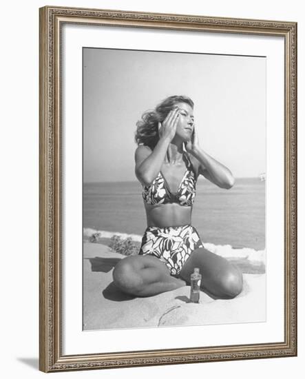 Woman Applying Suntan Lotion at the Beach-Peter Stackpole-Framed Photographic Print