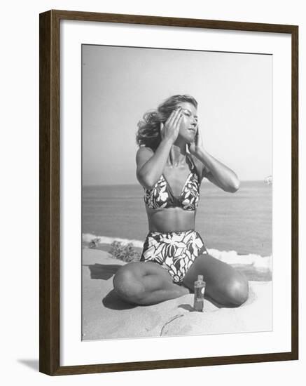 Woman Applying Suntan Lotion at the Beach-Peter Stackpole-Framed Photographic Print