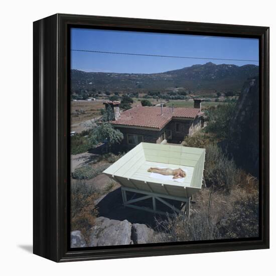 Woman as She Sunbathes Nude in on a Platform with Sides That Allow Privacy, Tecate, Mexico, 1961-Allan Grant-Framed Premier Image Canvas