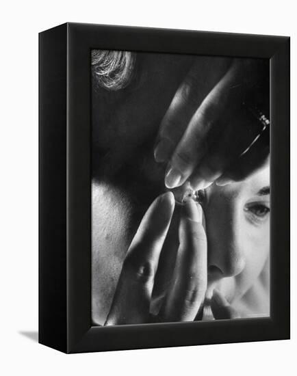 Woman Cautiously Placing a Contact Lens in Her Eye-Al Fenn-Framed Premier Image Canvas