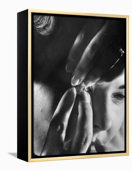 Woman Cautiously Placing a Contact Lens in Her Eye-Al Fenn-Framed Premier Image Canvas