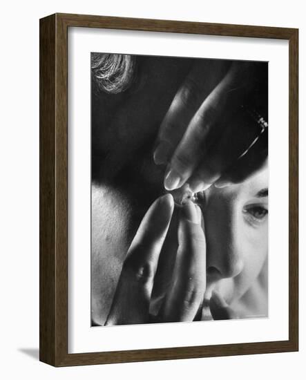 Woman Cautiously Placing a Contact Lens in Her Eye-Al Fenn-Framed Photographic Print