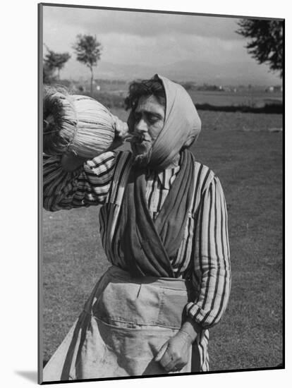 Woman Drinking a Bottles of Wine from a Story Concerning Italy-null-Mounted Photographic Print