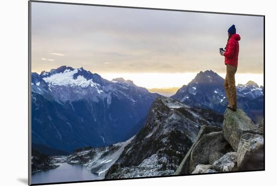 Woman Drinks Her Coffee On Top Of A Mountain In The Morning Looking Out Into The Cascade Mts In WA-Hannah Dewey-Mounted Photographic Print