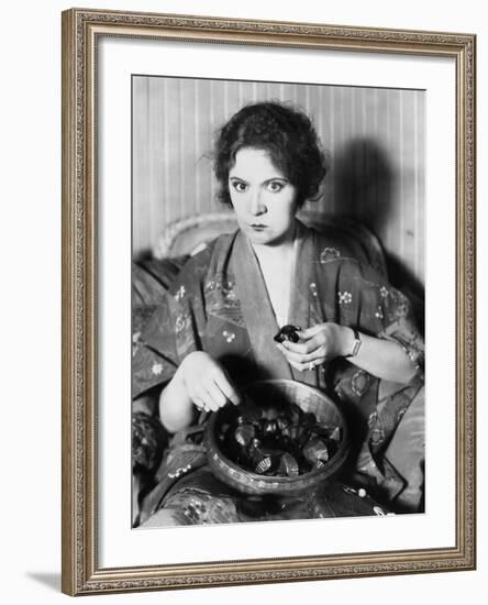 Woman Eating Chocolates Out of a Bowl-null-Framed Photo