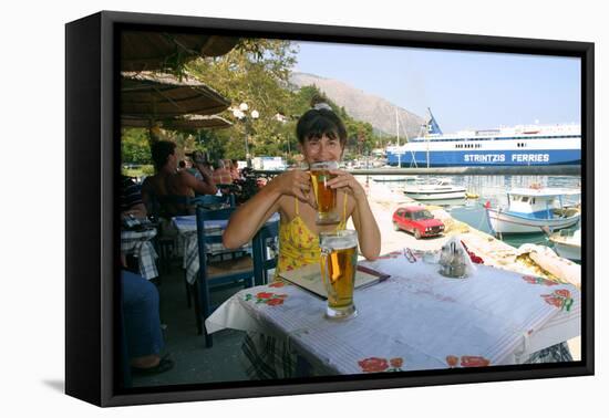 Woman Enjoying a Drink in a Harbourside Taverna, Poros, Kefalonia, Greece-Peter Thompson-Framed Premier Image Canvas