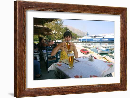 Woman Enjoying a Drink in a Harbourside Taverna, Poros, Kefalonia, Greece-Peter Thompson-Framed Photographic Print