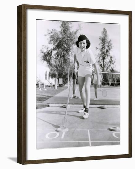 Woman Enjoying a Game of Shuffleboard-null-Framed Photo