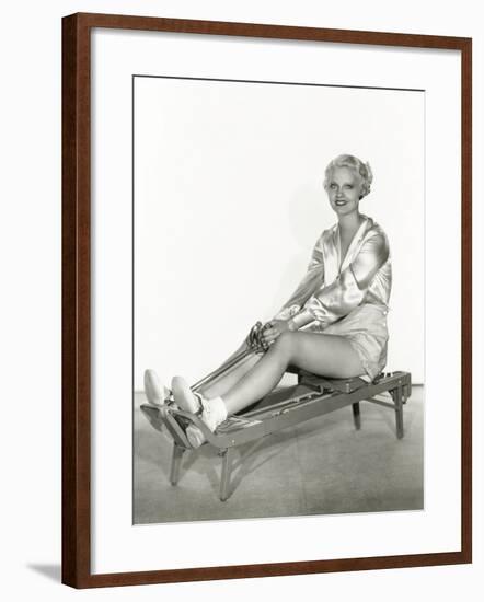 Woman Excersing on Rowing Machine-null-Framed Photo