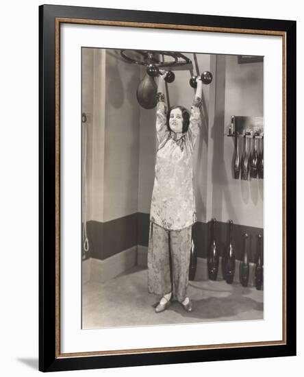 Woman Exercising in Silk Pajamas-null-Framed Photo