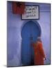Woman Exits thru Moorish-Style Blue Door, Morocco-Merrill Images-Mounted Photographic Print