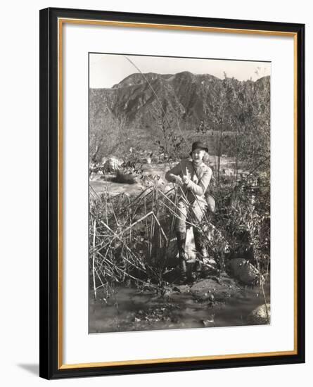 Woman Fishing on a River Bank-null-Framed Photo