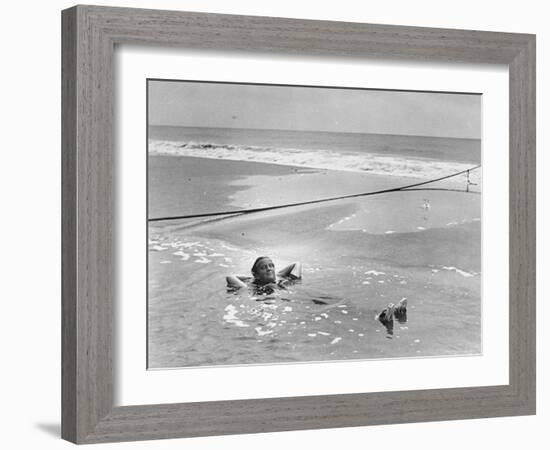 Woman Floating in a Large Puddle of Water Near the Surf While at the Beach-Wallace G^ Levison-Framed Photographic Print