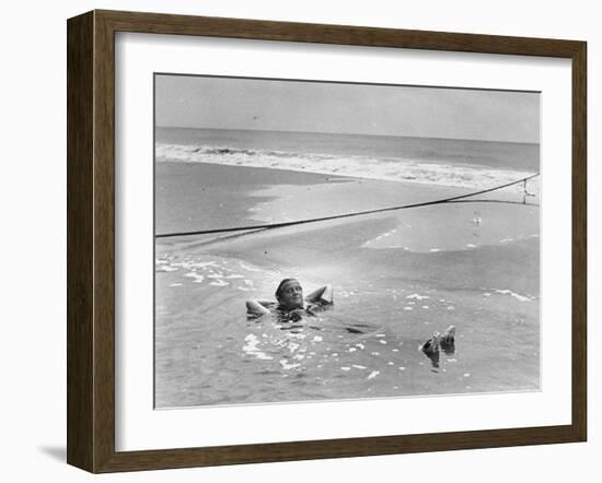 Woman Floating in a Large Puddle of Water Near the Surf While at the Beach-Wallace G^ Levison-Framed Photographic Print