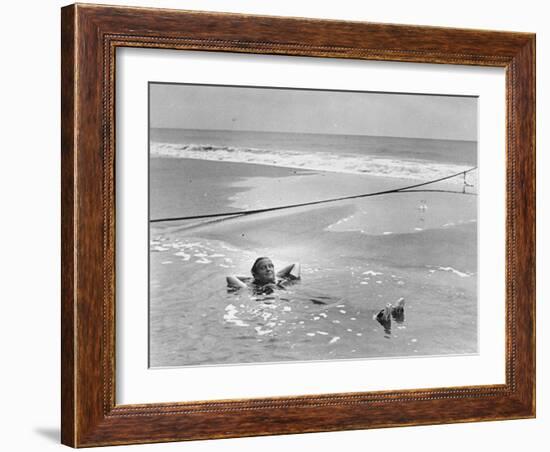 Woman Floating in a Large Puddle of Water Near the Surf While at the Beach-Wallace G^ Levison-Framed Photographic Print