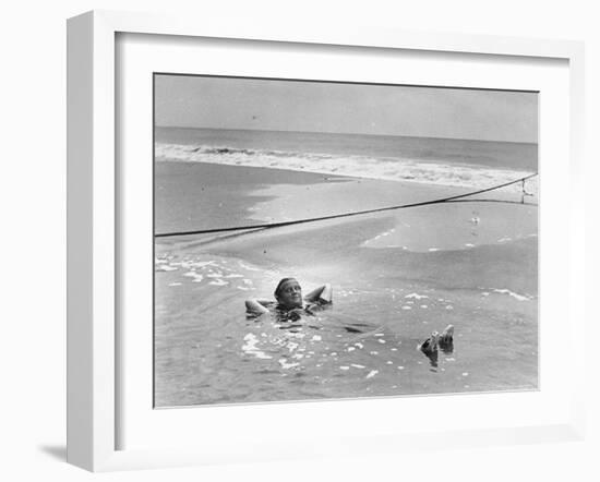 Woman Floating in a Large Puddle of Water Near the Surf While at the Beach-Wallace G^ Levison-Framed Photographic Print