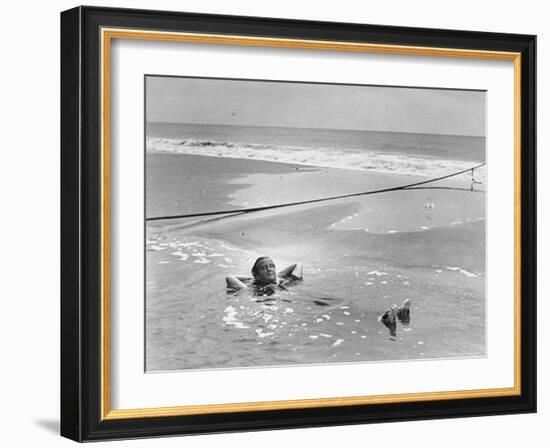 Woman Floating in a Large Puddle of Water Near the Surf While at the Beach-Wallace G^ Levison-Framed Photographic Print