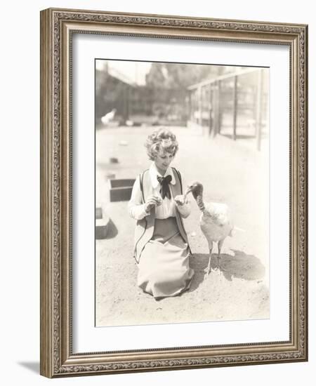 Woman Hand Feeding Turkey-null-Framed Photo