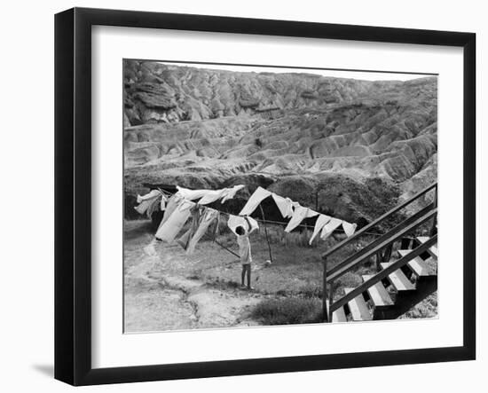 Woman Hanging Laundry with Land Erosion in the Background-Alfred Eisenstaedt-Framed Photographic Print