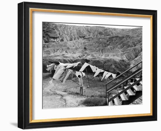 Woman Hanging Laundry with Land Erosion in the Background-Alfred Eisenstaedt-Framed Photographic Print