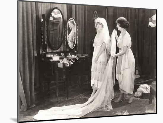 Woman Helping Bride Get Dressed-null-Mounted Photo