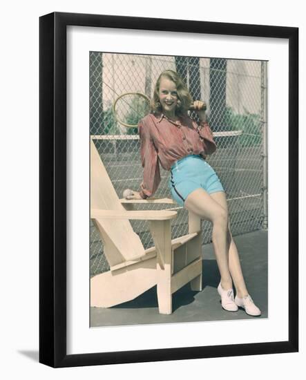 Woman Holding Tennis Racket-null-Framed Photo