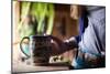 Woman Holds A Freshly Brewed Cup Of Tea In Her Home-Hannah Dewey-Mounted Photographic Print