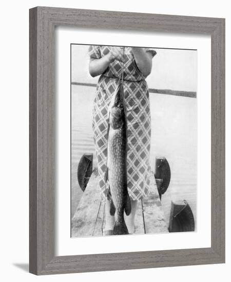 Woman Holds on Large Northern Pike on a Lake Pier, Ca. 1950-null-Framed Photographic Print